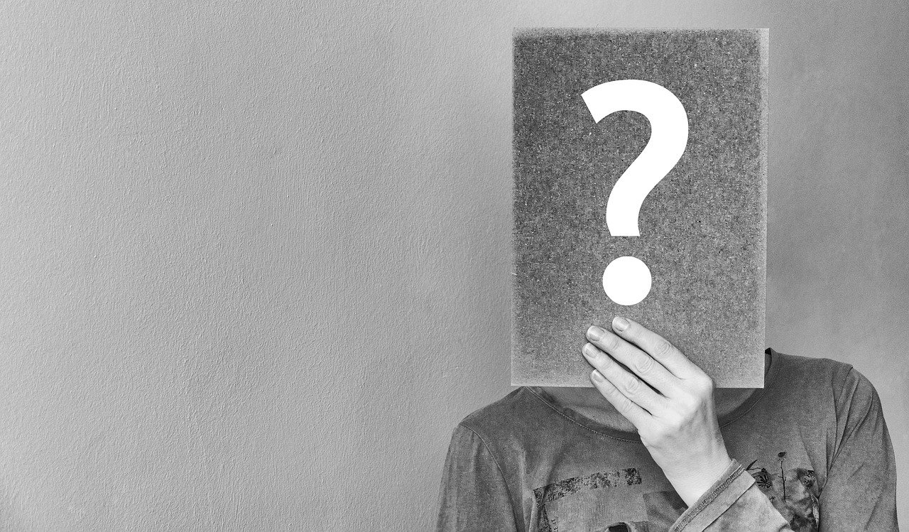 Person holding question mark sign